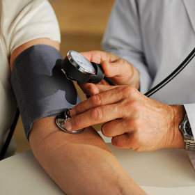 A patient having her blood pressure taken. A patient having her blood pressure taken.