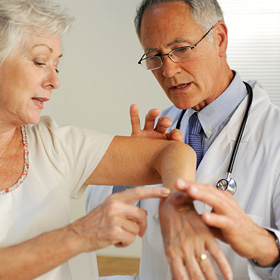 A doctor performs a physical health exam for his patient.
