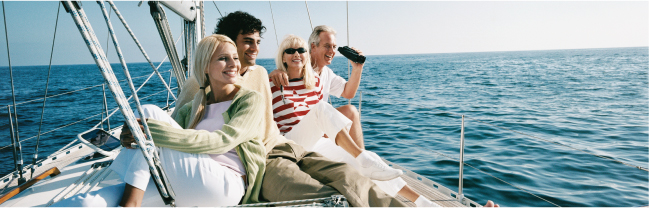 Two couples smiling while sailing